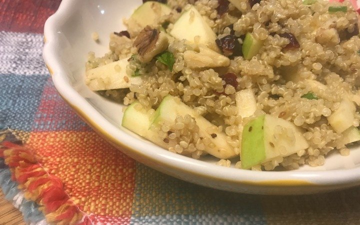 bowl of quinoa salad with cranberries, apples and walnuts