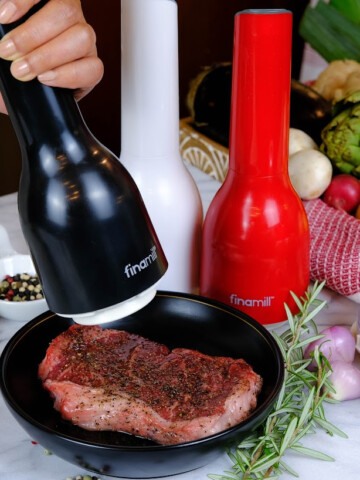black finamill spice grinder used on steak