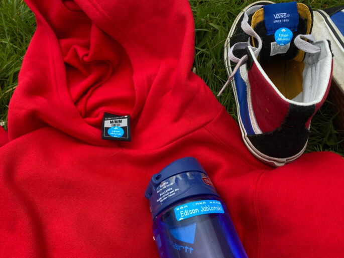 red-sweatshirt, sneaker, water bottle on grass
