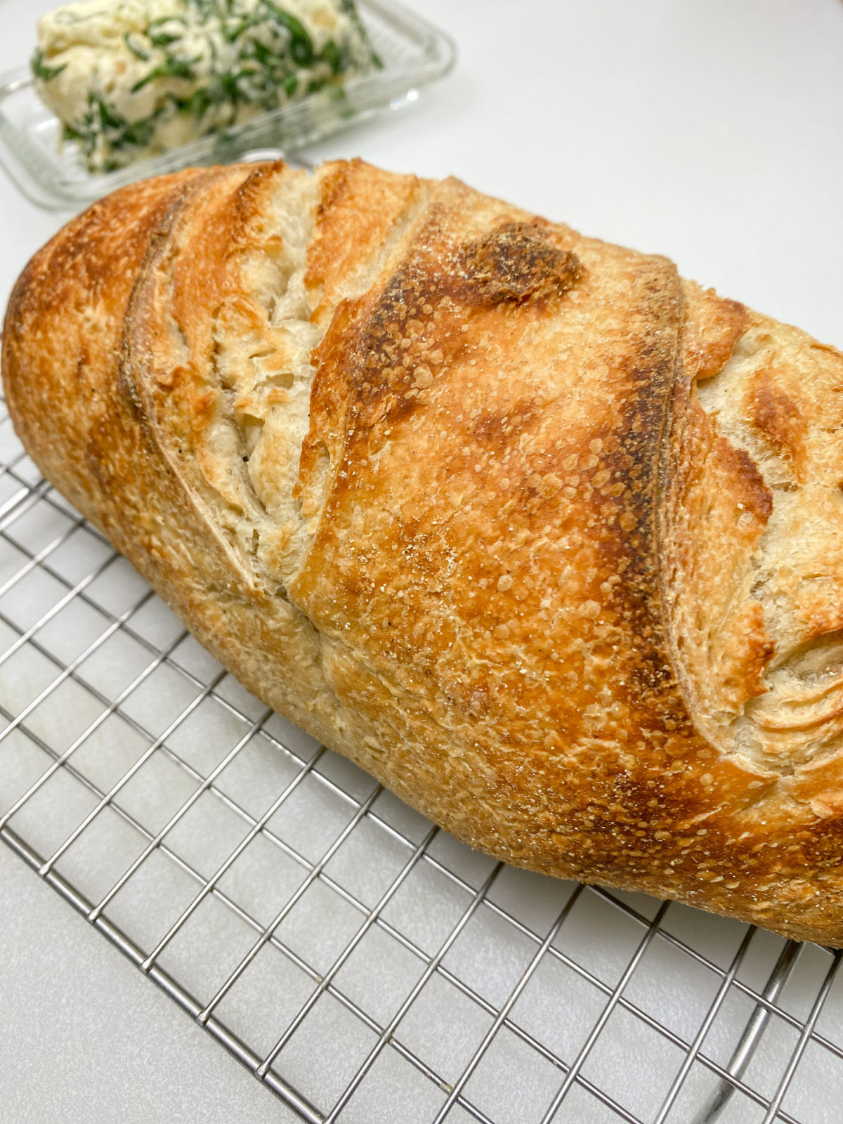 loaf of sourdough bread on wire rack